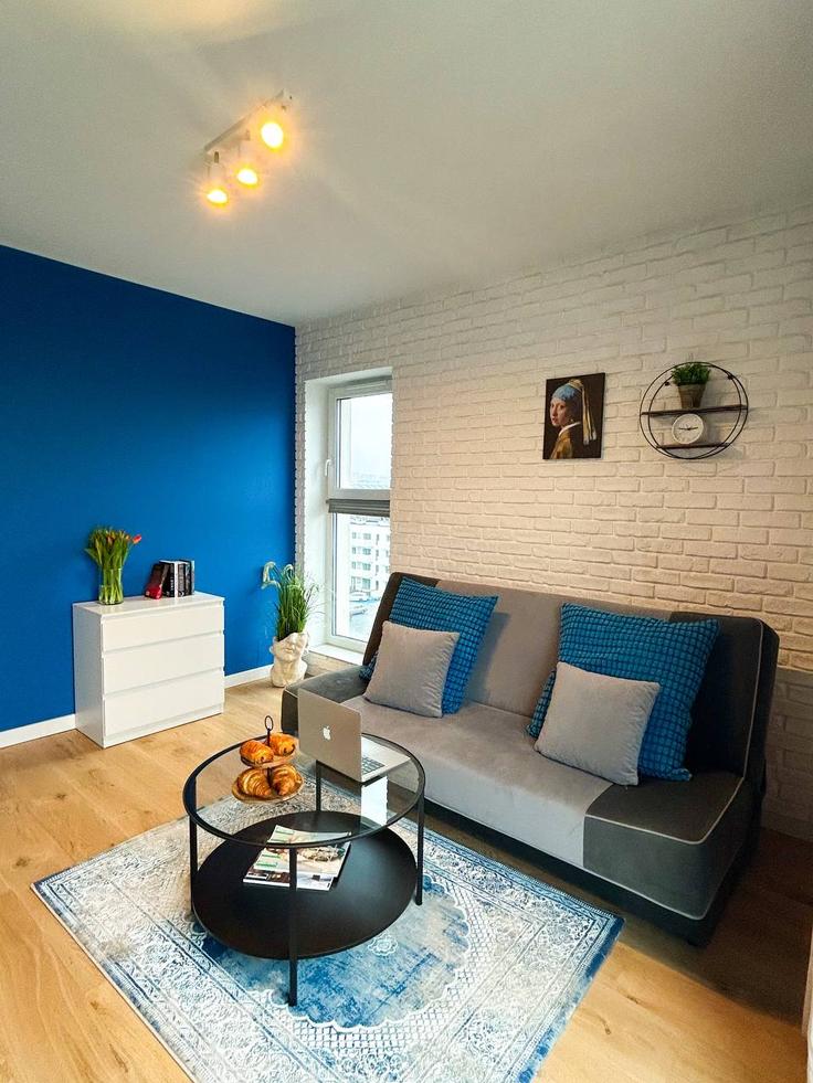 Elegant gestaltetes Wohnzimmer mit moderner Einrichtung in einer Wohnung im Building Generała Walerego Wróblewskiego - 7252289759 - 1465750 in Łódź, Łódź Elegant gestaltetes Wohnzimmer mit moderner Einrichtung in einer Wohnung im Building Generała Walerego Wróblewskiego - 7252289759 - 1465750 in Łódź, Łódź