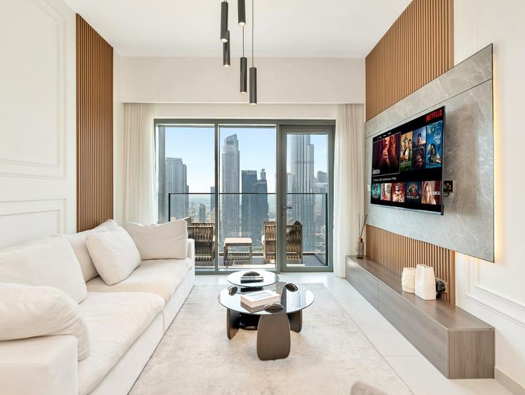Elegantly designed living room with modern furnishings in an apartment at Building Burj Khalifa Boulevard - abi-holiday-homes - 1496996 in Burj Khalifa, Dubai