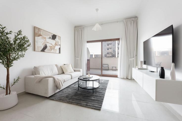 Elegantly designed living room with modern furnishings in an apartment at Building Mu'allaqat Boulevard - airdxb - 1310905 - DXB in Jumeirah Village, Dubai Elegantly designed living room with modern furnishings in an apartment at Building Mu'allaqat Boulevard - airdxb - 1310905 - DXB in Jumeirah Village, Dubai