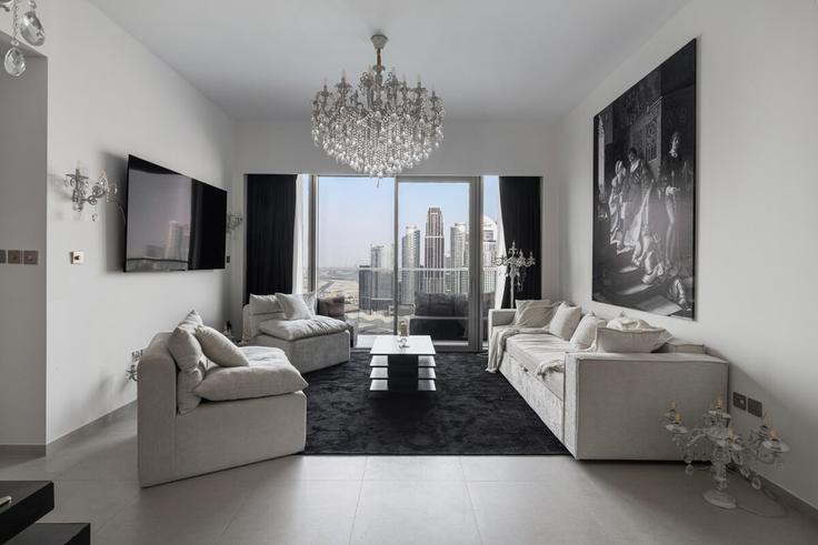 Sala de estar elegantemente projetada com móveis modernos em um apartamento no Building grande signature residences - bellagge-vacation-homes-llc - 1627107 em Burj Khalifa, Dubai Sala de estar elegantemente projetada com móveis modernos em um apartamento no Building grande signature residences - bellagge-vacation-homes-llc - 1627107 em Burj Khalifa, Dubai