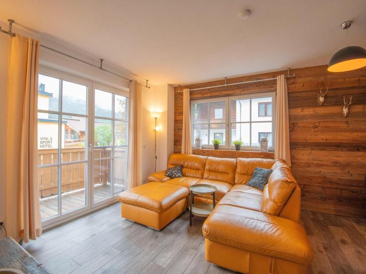 Elegante sala de estar con mobiliario moderno en un apartamento en Building Dorfstraße - belvilla-ag-dancenter-as - 1429786 en Brixen im Thale, Brixen im Thale
