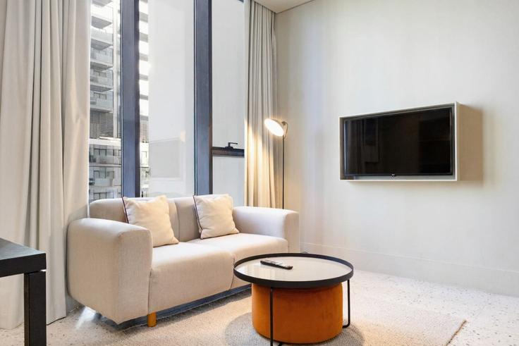 Sala de estar elegantemente projetada com móveis modernos em um apartamento no Building Tariaq Bedon Esm - bloomfields-holiday-home - 1474997 em Nad Al Sheba, Dubai