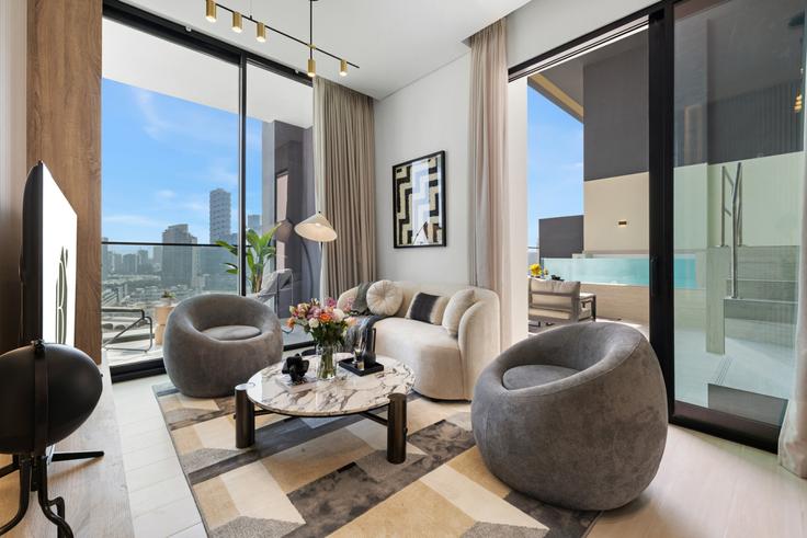 Elegantly designed living room with modern furnishings in an apartment at Building Street 5 - blvd-holiday-homes-rental-llc - 1515708 in Jumeirah Village, Dubai