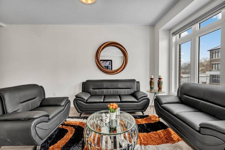 Elegantly designed living room with modern furnishings in an apartment at Building 585 Colborne Street - casa-co-host-1 - 1698579 in Brantford, Brantford