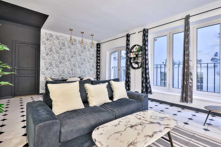 Elegante sala de estar con mobiliario moderno en un apartamento en Building Passage des Petites Écuries - checkmyguest - 1570791 en 10th arrondissement, Paris Elegante sala de estar con mobiliario moderno en un apartamento en Building Passage des Petites Écuries - checkmyguest - 1570791 en 10th arrondissement, Paris