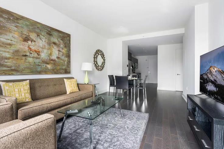 Elegantly designed living room with modern furnishings in an apartment at Building LaGuardia Pl - churchillliving - 1026613 - NYC in Manhattan, New York