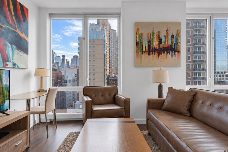 Elegantly designed living room with modern furnishings in an apartment at Building West 42nd Street - churchillliving - 1016126 in Manhattan, New York
