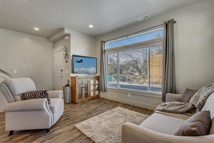Elegantly designed living room with modern furnishings in an apartment at Building North Hill Field Road - cloud-dream-homes-pllc - 1699429 in Layton, Layton