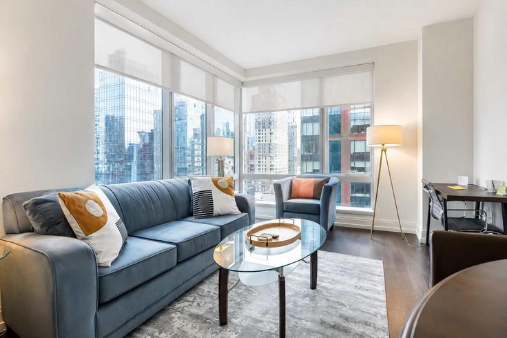Elegantly designed living room with modern furnishings in an apartment at Building 10th Avenue - compassfurnishedapartments - 1388515 in Manhattan, New York