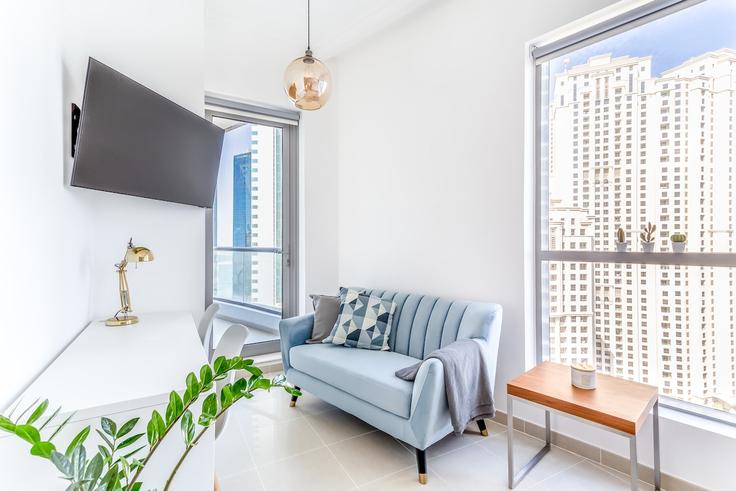 Elegantly designed living room with modern furnishings in an apartment at Building Marina Promenade - concrete-jungle - 1252058 - DXB in Dubai Marina, Dubai