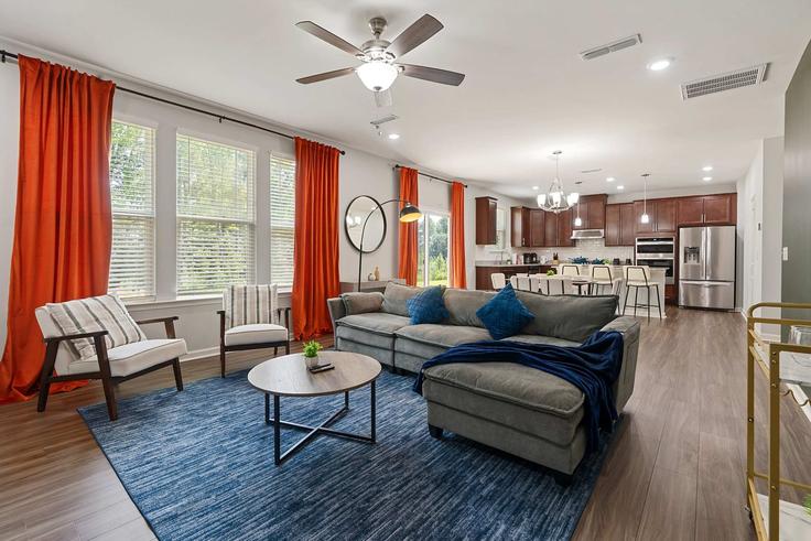 Elegantly designed living room with modern furnishings in an apartment at Building Potomac River Street - coveted-hospitality-llc - 1633275 in Garner, Garner Elegantly designed living room with modern furnishings in an apartment at Building Potomac River Street - coveted-hospitality-llc - 1633275 in Garner, Garner