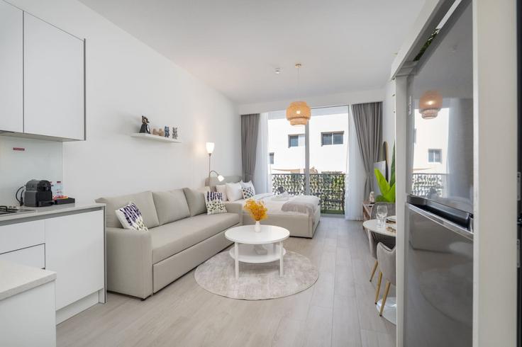 Elegantly designed living room with modern furnishings in an apartment at Building Street 10 - czechin-holiday-homes - 1505581 in Jumeirah Village, Dubai
