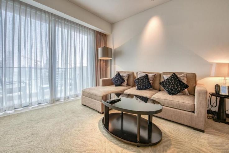 Elegantly designed living room with modern furnishings in an apartment at Building Tariaq Bedon Esm - dlx-holiday-homes - 1238539 - DXB in Dubai Marina, Dubai