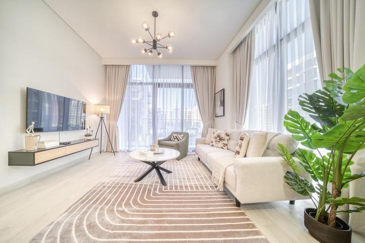 Elegantly designed living room with modern furnishings in an apartment at Building Al Meydan Road - dlx-holiday-homes - 1238772 - DXB in Nad Al Sheba, Dubai