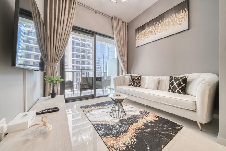 Elegantly designed living room with modern furnishings in an apartment at Building Al A'amal Street - dlx-holiday-homes - 1238817 in Business Bay, Dubai