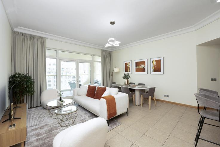 Elegantly designed living room with modern furnishings in an apartment at Building Palm Jumeirah Rd - dvh-holiday-homes-llc - 1312085 - DXB in The Palm Jumeirah, Dubai Elegantly designed living room with modern furnishings in an apartment at Building Palm Jumeirah Rd - dvh-holiday-homes-llc - 1312085 - DXB in The Palm Jumeirah, Dubai
