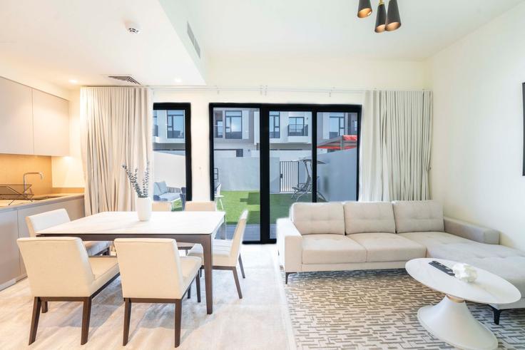 Elegantly designed living room with modern furnishings in an apartment at Building Tariaq Bedon Esm - easy-go-vacation-homes-rental-llc - 1462096 in Madinat Al Mataar, Dubai
