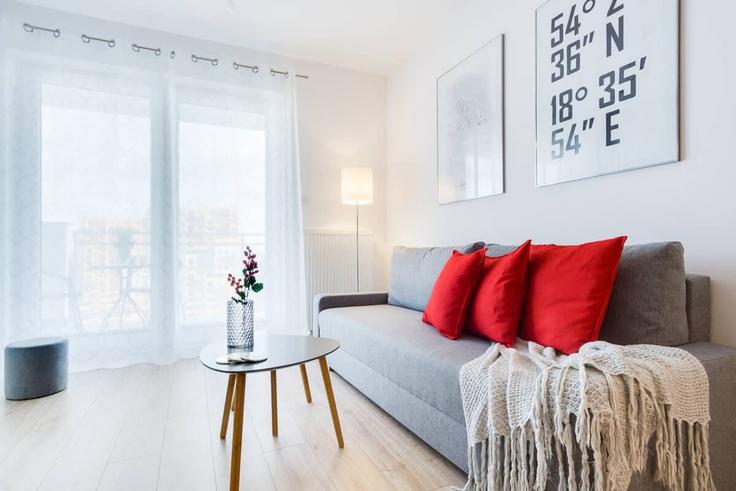 Salle de séjour élégante avec mobilier moderne dans un appartement à Building Obrońców Wybrzeża - elite-apartments - 1320098 à Gdańsk, Gdańsk Salle de séjour élégante avec mobilier moderne dans un appartement à Building Obrońców Wybrzeża - elite-apartments - 1320098 à Gdańsk, Gdańsk