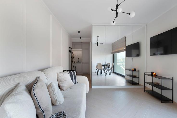 Sala de estar elegantemente projetada com móveis modernos em um apartamento no Building Kotwiczników - elite-apartments - 1320046 em Gdańsk, Gdańsk Sala de estar elegantemente projetada com móveis modernos em um apartamento no Building Kotwiczników - elite-apartments - 1320046 em Gdańsk, Gdańsk