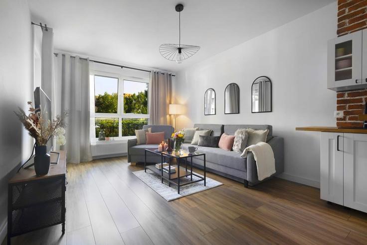 Gdańsk GdańskのBuilding Obrońców Wybrzeża - elite-apartments - 1320154のアパートメントにある、モダンな家具を備えたエレガントなデザインのリビングルーム Gdańsk GdańskのBuilding Obrońców Wybrzeża - elite-apartments - 1320154のアパートメントにある、モダンな家具を備えたエレガントなデザインのリビングルーム