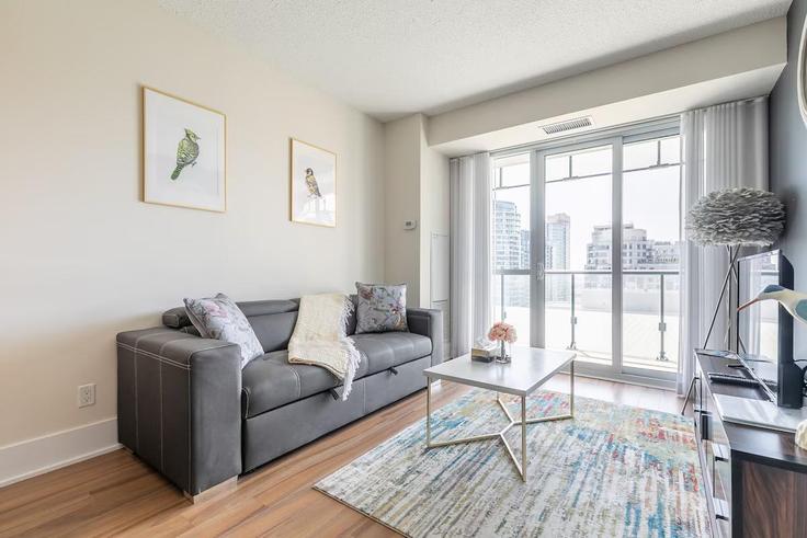 Elegantly designed living room with modern furnishings in an apartment at Building Front Street West - globalstayinc - 1462207 in Old Toronto, Toronto