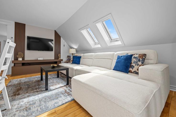 Elegantly designed living room with modern furnishings in an apartment at Building Hillsborough Street - hennessey-properties - 1699046 in Charlottetown, Charlottetown
