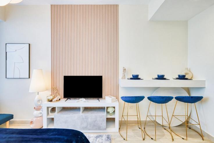 Elegantly designed living room with modern furnishings in an apartment at Building Street 10 - hive-holiday-homes-dubai - 1256282 in Jumeirah Village, Dubai