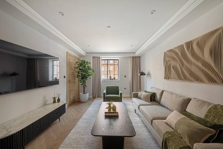 Elegante sala de estar con mobiliario moderno en un apartamento en Building Kensington High Street - hive-stays-ltd - 1534629 en Royal Borough of Kensington and Chelsea, London