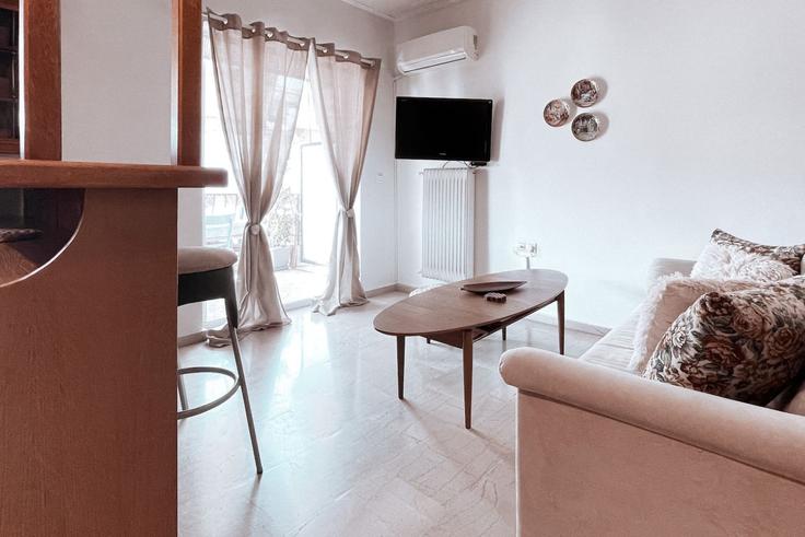 Elegantly designed living room with modern furnishings in an apartment at Building Friderikou Smith - ivy-vacation-rentals - 1503041 in Central Athens, Athens