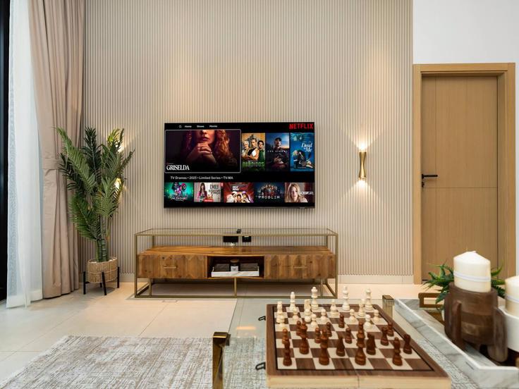Elegantly designed living room with modern furnishings in an apartment at Building Kaheel Blvd - kensington-holiday-homes-rental-llc - 1265812 - DXB in Jumeirah Village, Dubai