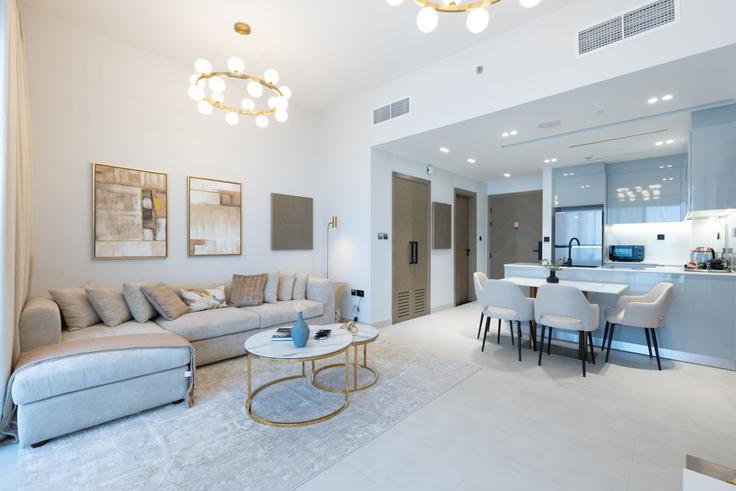 Elegantly designed living room with modern furnishings in an apartment at Building Marasi Drive - keyrock-holiday-homes - 1261299 - DXB in Business Bay, Dubai Elegantly designed living room with modern furnishings in an apartment at Building Marasi Drive - keyrock-holiday-homes - 1261299 - DXB in Business Bay, Dubai