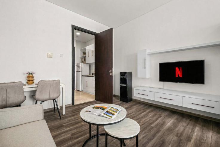 Elegantly designed living room with modern furnishings in an apartment at Building Jalan Jenderal Sudirman - kozystay-1 - 1695877 in Central Jakarta, Jakarta
