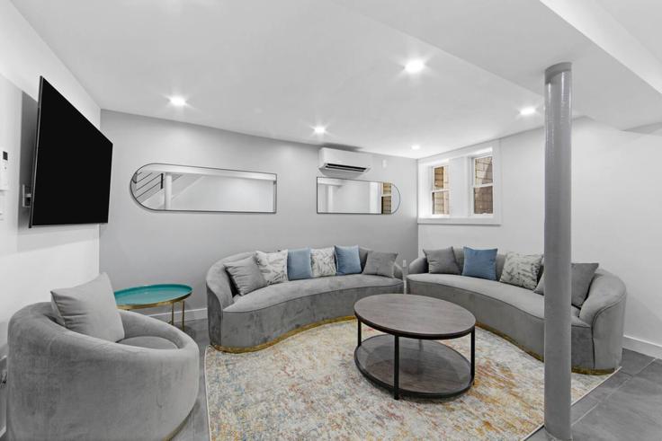 Elegantly designed living room with modern furnishings in an apartment at Building West 182nd Street - max-lux-rentals - 1302125 in Manhattan, New York