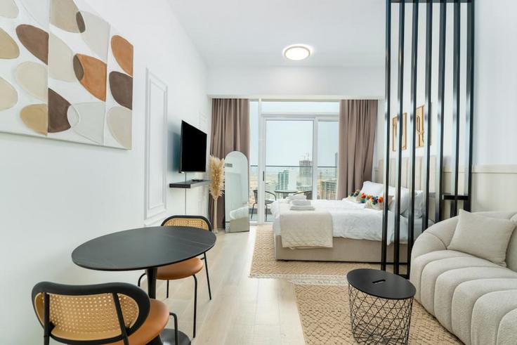 Elegantly designed living room with modern furnishings in an apartment at Building Lazuward South West - medini-homes - 1333456 in Jumeirah Village, Dubai Elegantly designed living room with modern furnishings in an apartment at Building Lazuward South West - medini-homes - 1333456 in Jumeirah Village, Dubai