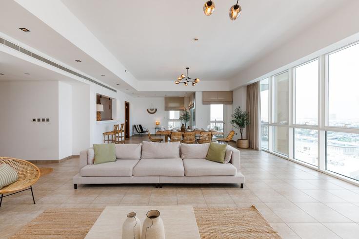 Elegantly designed living room with modern furnishings in an apartment at Building Palm Jumeirah Rd - mint-stay-homes-rental-llc - 1296449 - DXB in The Palm Jumeirah, Dubai Elegantly designed living room with modern furnishings in an apartment at Building Palm Jumeirah Rd - mint-stay-homes-rental-llc - 1296449 - DXB in The Palm Jumeirah, Dubai