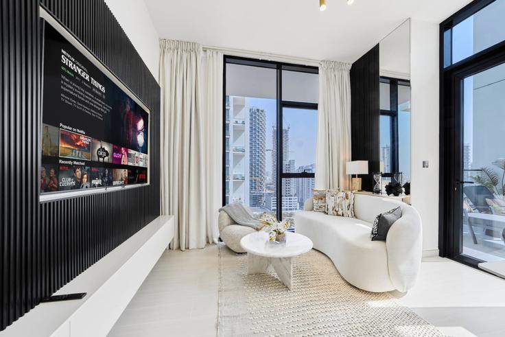 Elegant gestaltetes Wohnzimmer mit moderner Einrichtung in einer Wohnung im Building Assel Blvd - nexusliving - 1460855 in Jumeirah Village, Dubai