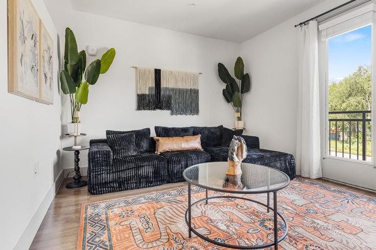 Elegantly designed living room with modern furnishings in an apartment at Building South Interstate 35 Frontage Road - oh-management-usa-llc - 1592203 in Austin, Austin