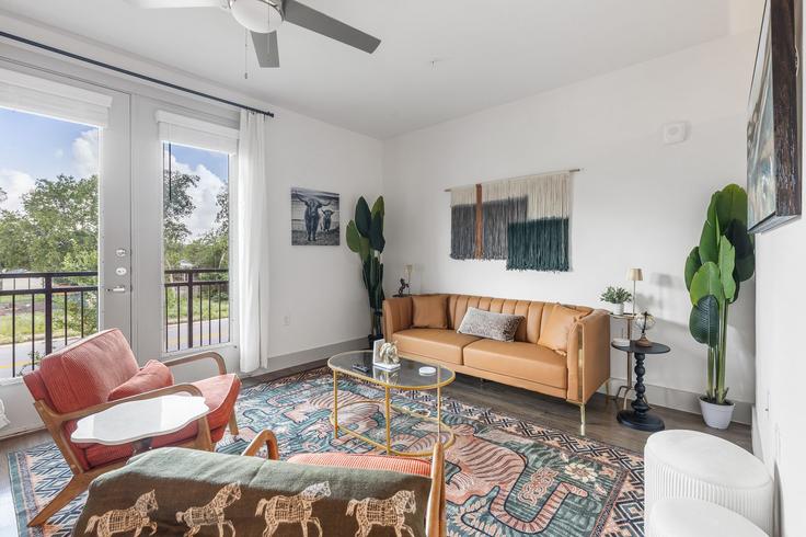 Elegantly designed living room with modern furnishings in an apartment at Building South Interstate 35 Frontage Road - oh-management-usa-llc - 1592298 in Austin, Austin