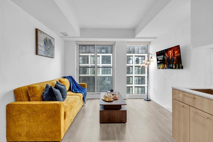 Elegantly designed living room with modern furnishings in an apartment at Building Jarvis Street - rivetstays-ontario-inc - 1520561 in Old Toronto, Toronto