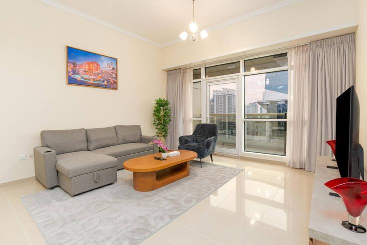 Elegantly designed living room with modern furnishings in an apartment at Building Tariaq Bedon Esm - samaya-vacation-homes - 1388784 in JLT, Dubai