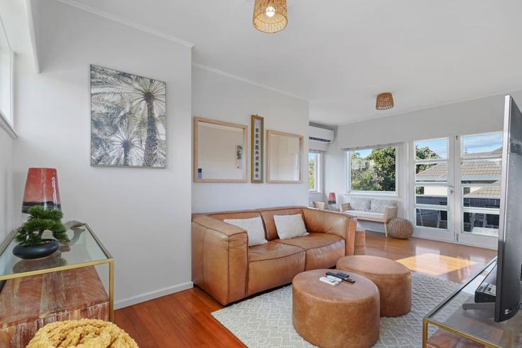 Sala de estar elegantemente projetada com móveis modernos em um apartamento no Building Eastern Beach Road - stayhub - 1291915 - NZL em Eastern Beach, Auckland