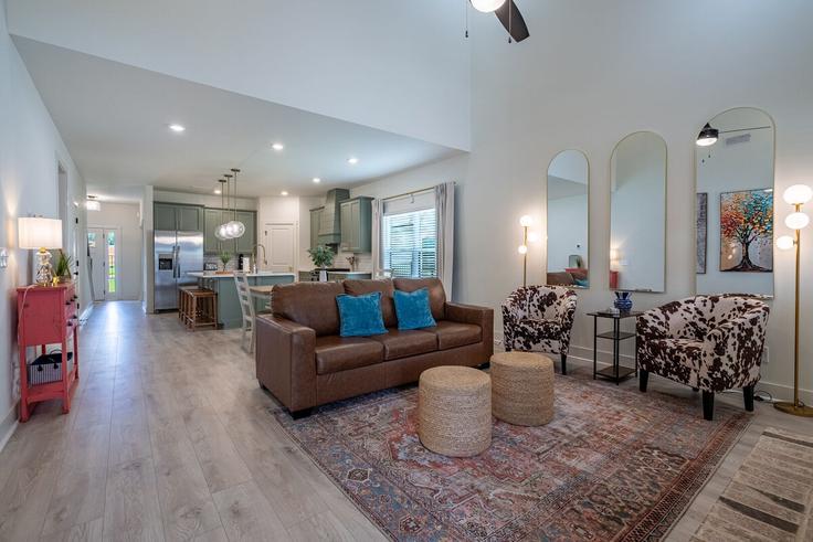 Elegantly designed living room with modern furnishings in an apartment at Building Puckett Road Southeast - suite-stays-atlanta - 1549275 in Emerson, Emerson