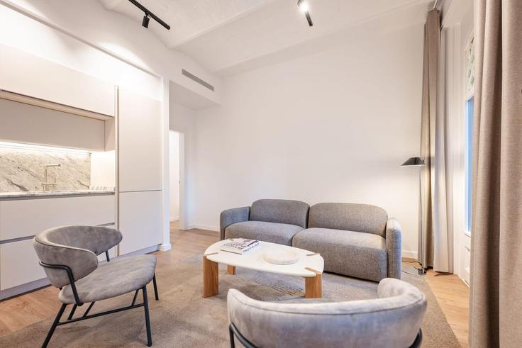 Elegante sala de estar con mobiliario moderno en un apartamento en Building Avinguda Diagonal - sweett - 1073748 - BCN en Eixample, Barcelona Elegante sala de estar con mobiliario moderno en un apartamento en Building Avinguda Diagonal - sweett - 1073748 - BCN en Eixample, Barcelona