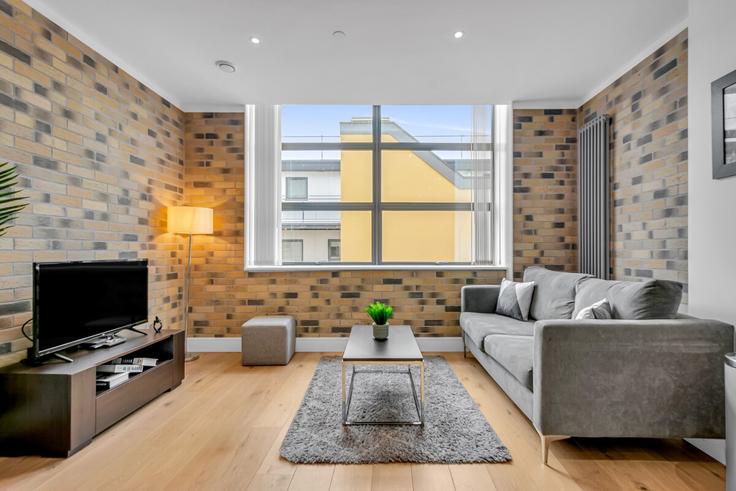 Sala de estar elegantemente projetada com móveis modernos em um apartamento no Building Arlington Road - thesquare-serviced-apartments - 1271960 - LON em London Borough of Camden, London Sala de estar elegantemente projetada com móveis modernos em um apartamento no Building Arlington Road - thesquare-serviced-apartments - 1271960 - LON em London Borough of Camden, London