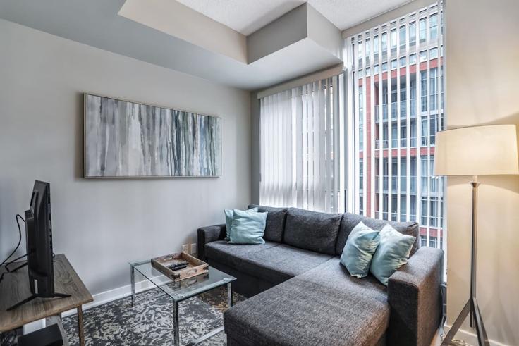 Elegantly designed living room with modern furnishings in an apartment at Building Nelson Street - to-stays-inc - 1471513 in Old Toronto, Toronto Elegantly designed living room with modern furnishings in an apartment at Building Nelson Street - to-stays-inc - 1471513 in Old Toronto, Toronto