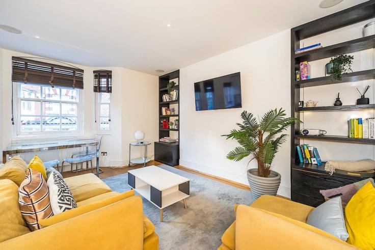 Elegante sala de estar con mobiliario moderno en un apartamento en Building Great Portland Street - udoma-limited - 1438294 en City of Westminster, London Elegante sala de estar con mobiliario moderno en un apartamento en Building Great Portland Street - udoma-limited - 1438294 en City of Westminster, London