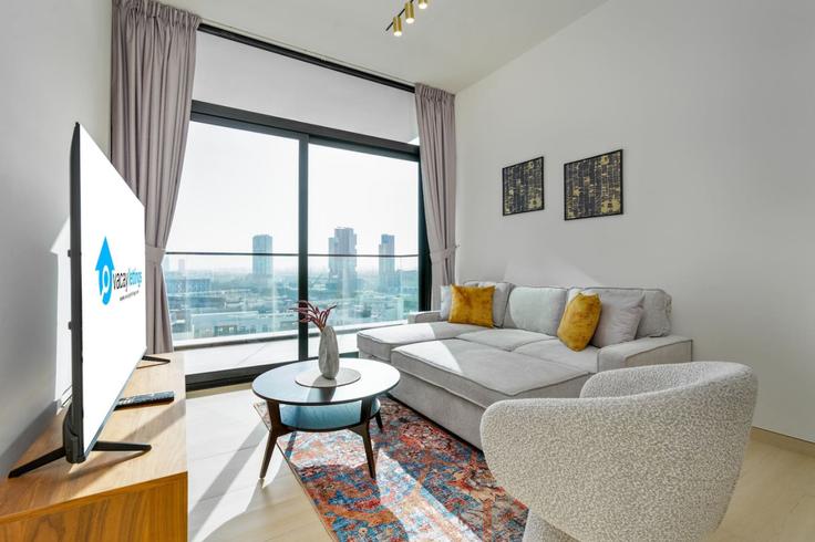Elegantly designed living room with modern furnishings in an apartment at Building Kahraba North West - vacaylettingsvacationshomesrental - 1057499 - DXB in Jumeirah Village, Dubai