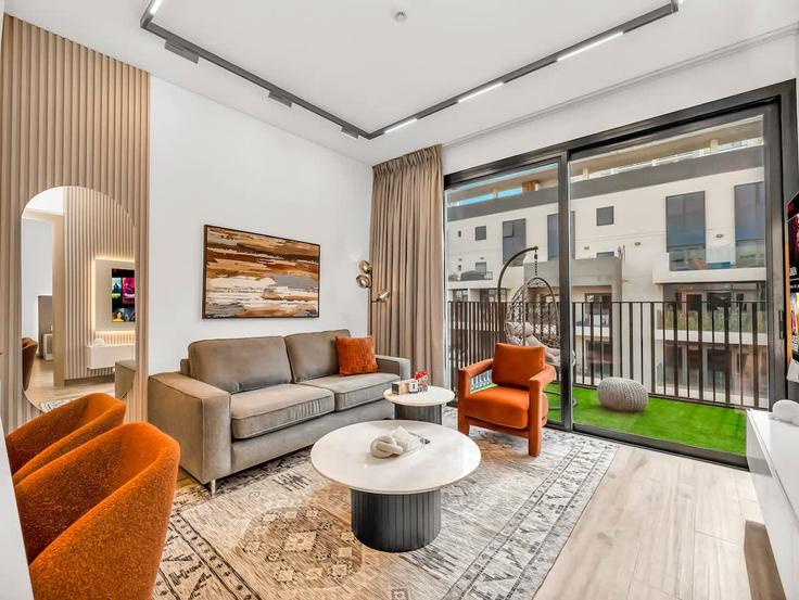 Elegantly designed living room with modern furnishings in an apartment at Building Tariaq Bedon Esm - zarrien-holiday-homes - 1421747 in Jumeirah Village, Dubai Elegantly designed living room with modern furnishings in an apartment at Building Tariaq Bedon Esm - zarrien-holiday-homes - 1421747 in Jumeirah Village, Dubai