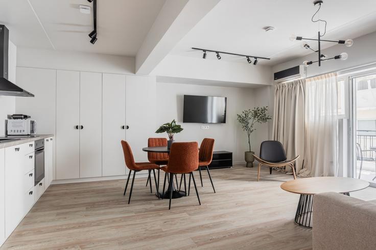 Dining table with stylish chairs in an apartment at Building Agiou Nikolaou - zoialiving - 1299484 - ATH in Central Athens, Athens