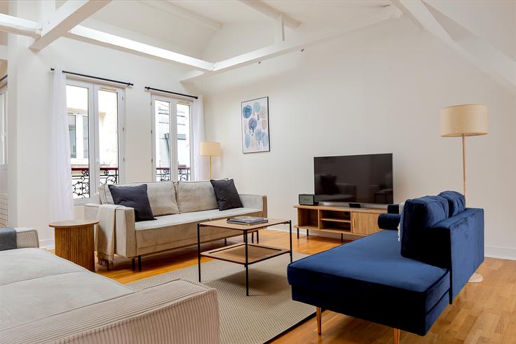 Elegantly designed living room with modern furnishings in an apartment at Alibert 13 in 10th arrondissement, Paris